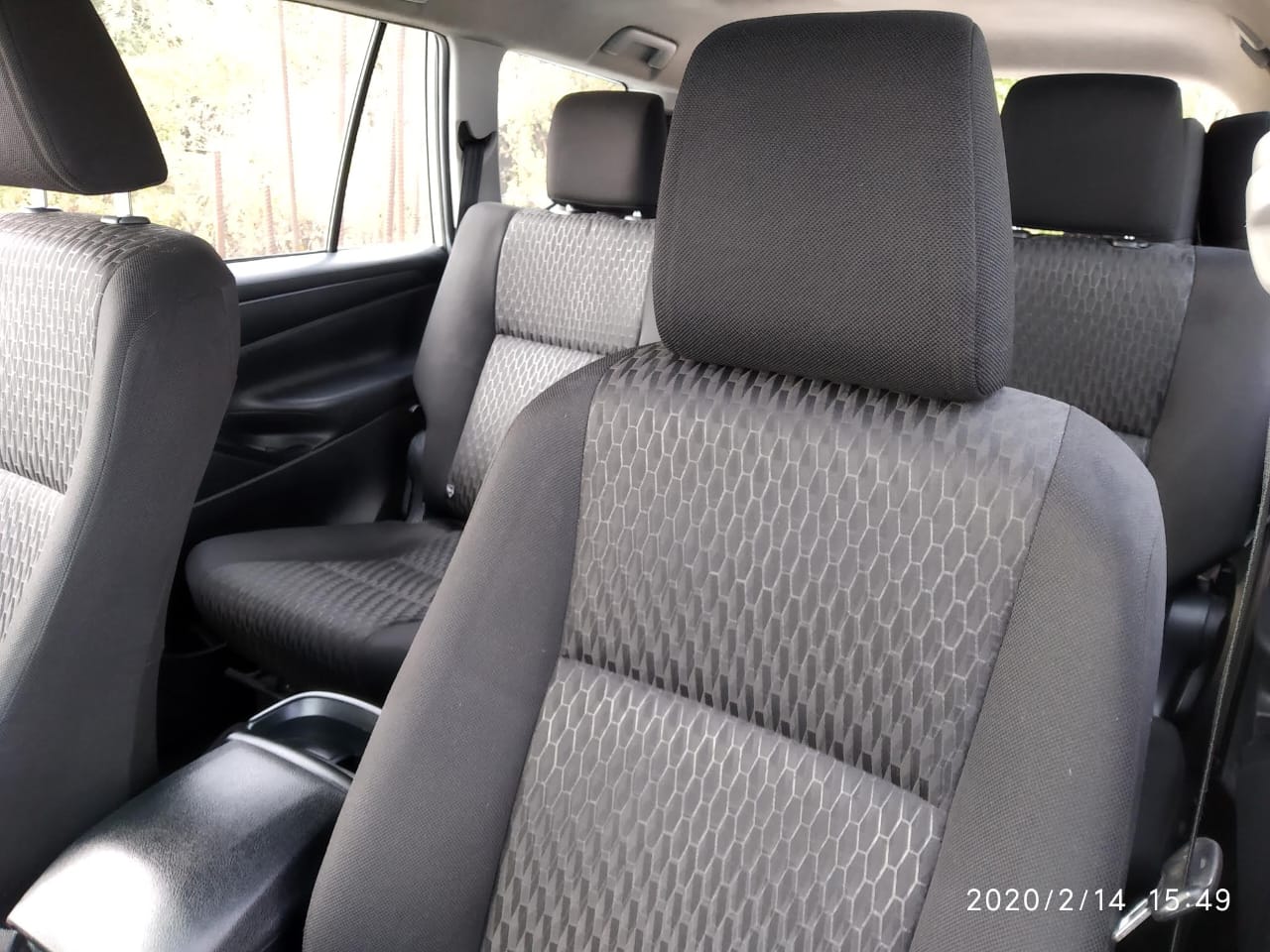 Interior of a well-maintained taxi, showcasing comfortable seating and ample space for a relaxing journey through Himachal Pradesh.