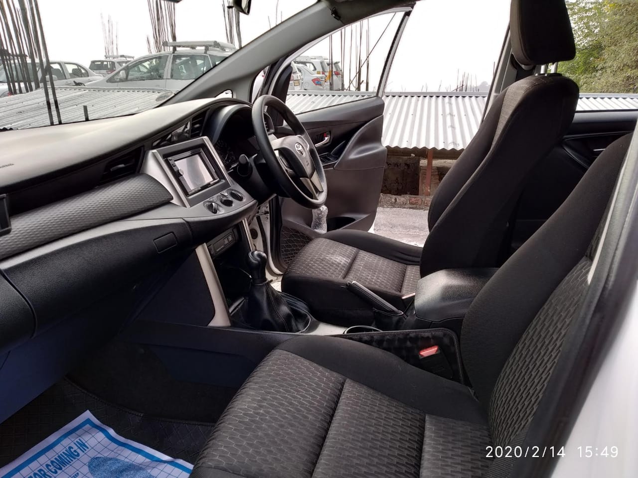 Interior of a well-maintained taxi, showcasing comfortable seating and ample space for a relaxing journey through Himachal Pradesh.