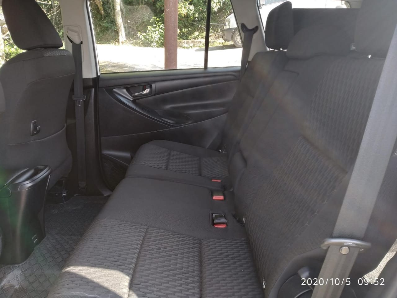 Interior of a well-maintained taxi, showcasing comfortable seating and ample space for a relaxing journey through Himachal Pradesh.