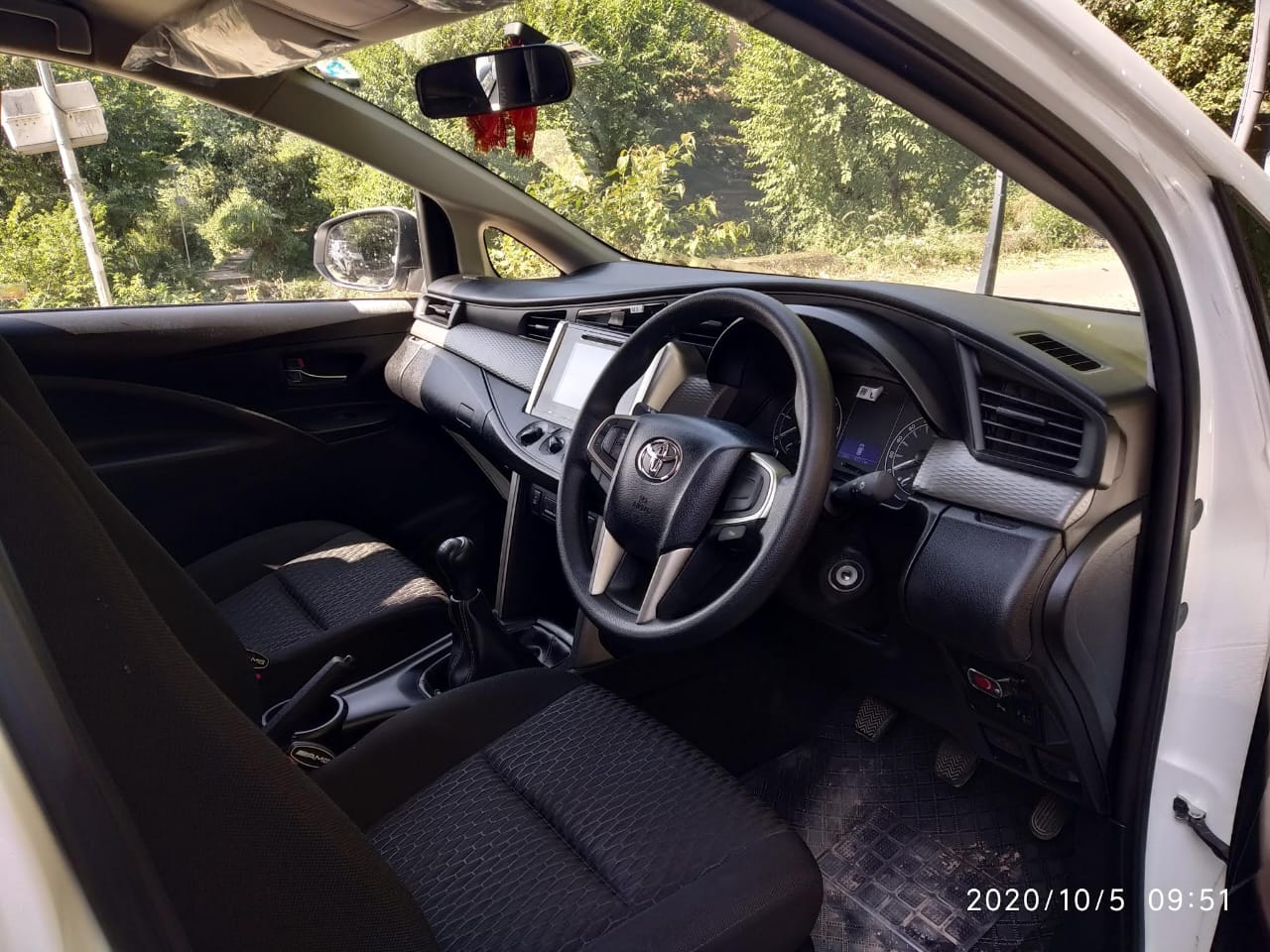 Interior of a well-maintained taxi, showcasing comfortable seating and ample space for a relaxing journey through Himachal Pradesh.