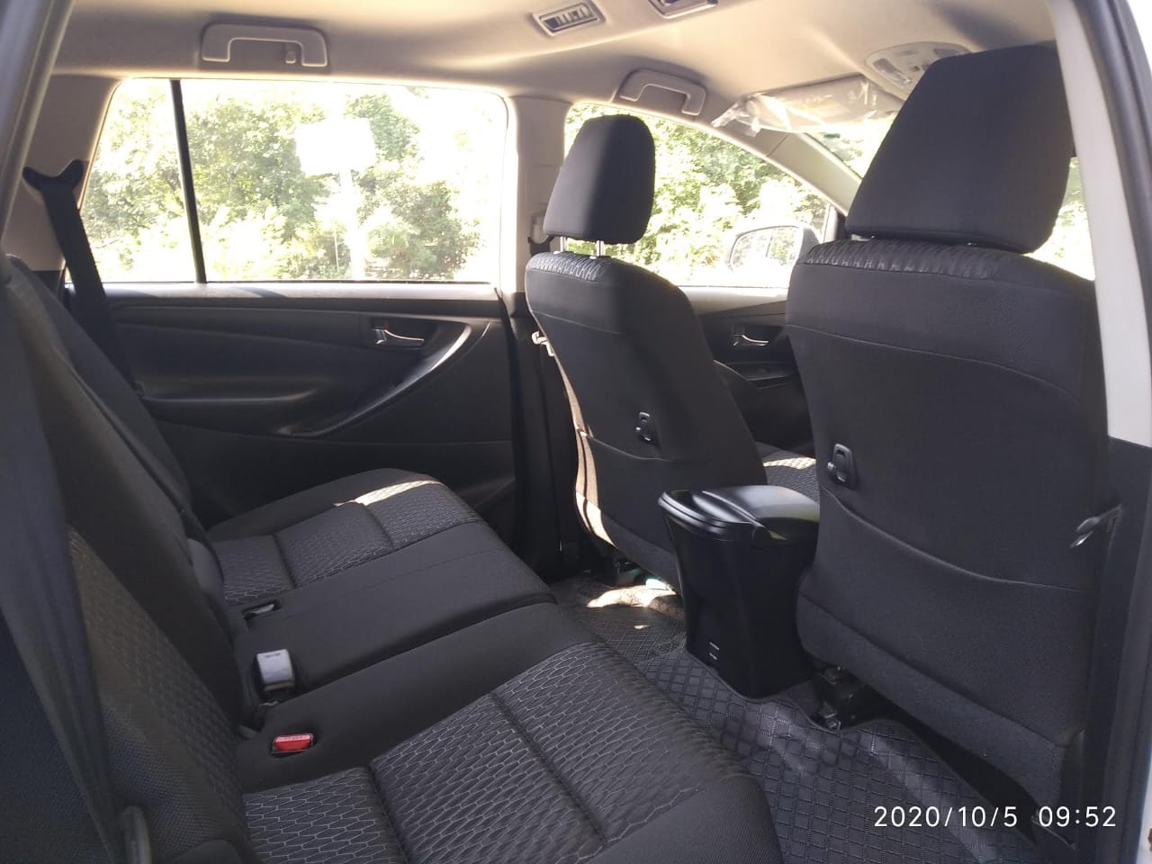 Interior of a well-maintained taxi, showcasing comfortable seating and ample space for a relaxing journey through Himachal Pradesh.