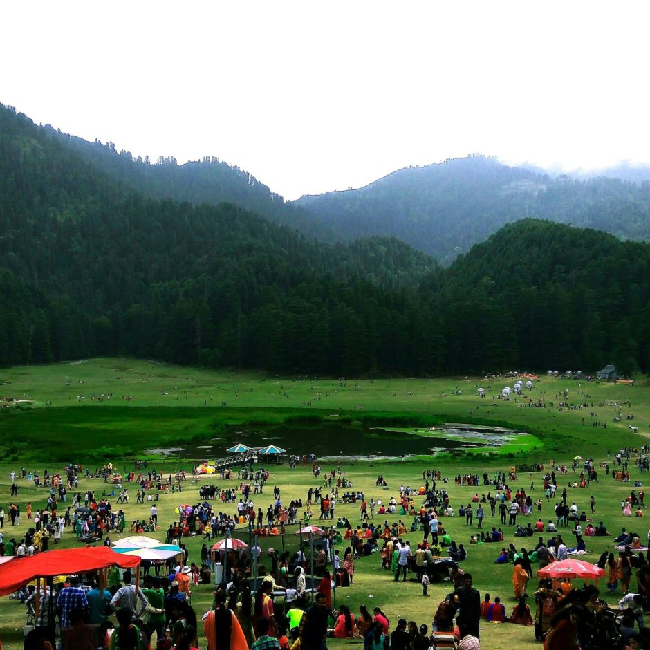 Lush green meadows of Khajjiar, Himachal Pradesh, ideal for scenic travel with a trusted taxi service.